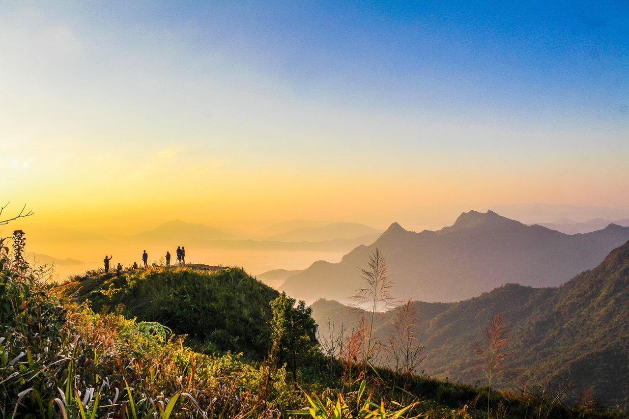 Home Photo Of People Standing On Top Of Mountain Near Grasses 733162